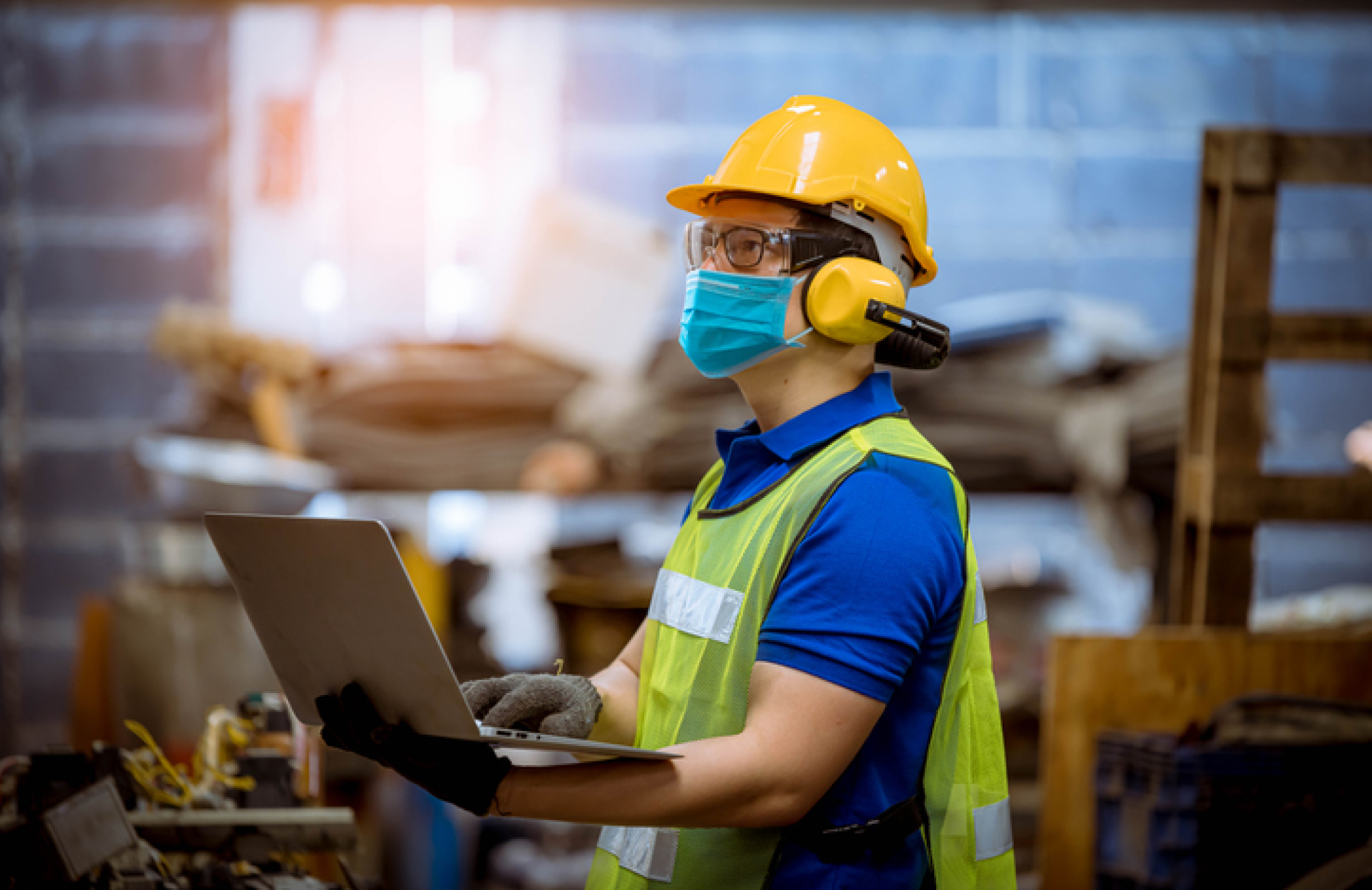 Portrait man worker under inspection and checking production process on factory station by wearing safety mask to protect for pollution and virus in factory.